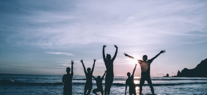 people jumping into the ocean